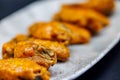 Plate of Buffalo chicken wings on a black background