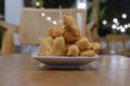 A plate of a bunch of Fried Meatballs with chili sauce