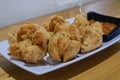 A plate of a bunch of Fried Meatballs with chili sauce