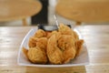 A plate of a bunch of Fried Meatballs with chili sauce