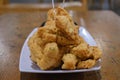 A plate of a bunch of Fried Meatballs with chili sauce