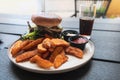 Plate with burger and french fries, ketchup and mayonnaise and cola on the table. Royalty Free Stock Photo