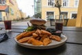 Plate with burger and french fries, ketchup and mayonnaise and cola on the table. Royalty Free Stock Photo