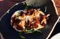 Plate of burrata salad on wooden surface