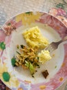 Plate with cabbage salad, leftovers of herring and fork full of potato mash