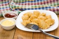 Plate with chebureks, bowl with ketchup and mayonnaise, checkered towel