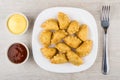 Plate with chebureks, bowl with ketchup, mayonnaise and fork