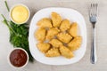 Plate with chebureks, bowl with ketchup and mayonnaise, parsley, dill