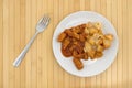 Plate with chicken chunks in barbecue sauce plus potatoes Royalty Free Stock Photo