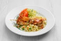 Plate with chicken shashlik, rice with peas and cabbage salad