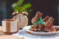 Plate with chocolate bunnies beside retro alarm Royalty Free Stock Photo