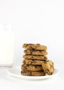 Plate with chocolate chip cookies and glass of milk on white background Royalty Free Stock Photo