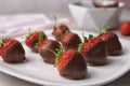 Plate with chocolate covered strawberries on table Royalty Free Stock Photo