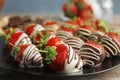 Plate with chocolate covered strawberries on table Royalty Free Stock Photo