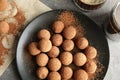 Plate with chocolate truffles on grey background Royalty Free Stock Photo