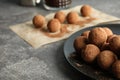 Plate with chocolate truffles on grey background Royalty Free Stock Photo