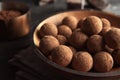 Plate with chocolate truffles on table Royalty Free Stock Photo