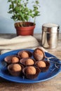 Plate with chocolate truffles on table Royalty Free Stock Photo