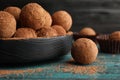 Plate of chocolate truffles on wooden table Royalty Free Stock Photo