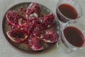 Plate with chopped pomegranate and wine glasses with juice