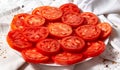 Plate with chopped tomatoes. Tomato slices lie in two layers, you can see the cut and seeds.