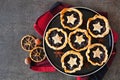 Plate of Christmas mincemeat tarts over a dark background