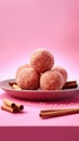 Plate of cinnamon doughnuts on a pink background