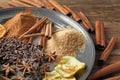 Plate with cinnamon, spices and sugar on table, closeup Royalty Free Stock Photo