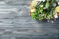 Plate with citrus essential oil, lime and herbs on wooden background