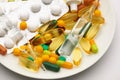 Plate closeup with set of pills, tablets, vitamins, drugs, omega 3 fish oil, gel capsules, medicament and food supplement for Royalty Free Stock Photo