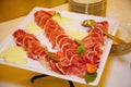 Plate of cold meats in the restaurant. Meat snacks. Smoked sausage and bacon, Royalty Free Stock Photo