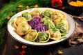 a plate of colorful polish pierogi dumplings garnished with herbs