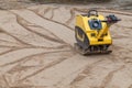 Plate compactor at a construction site. Royalty Free Stock Photo