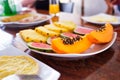 Plate containing pieces of fruit, papaya, watermelon and pineapple