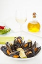 Plate of coocked mussels with lemon isolated over white