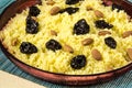 Plate with cooked couscous with almond and prunes