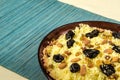 Plate with cooked couscous with almond, raisins and prunes