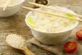 Plate of cooked long-grain rice on wooden background. Healthy eating, diet, vegetarianism. Royalty Free Stock Photo