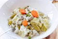 Plate with cooked mixed vegetables on wooden table, Spanish cuisine Menestra de Verduras.