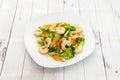 Plate of cooked peeled prawns with broccoli al dente and carrot slices