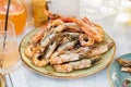 plate with Cooked seafood on a barbecue grill. Grilled shrimp. Royalty Free Stock Photo