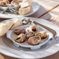 Plate with cooked snails in a rustic restaurant closeup Royalty Free Stock Photo