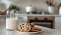 Plate with cookies and glass of milk on table in modern kitchen Royalty Free Stock Photo