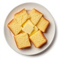 A plate of cornbread slices with butter, isolated on a white Royalty Free Stock Photo