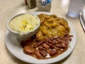 Plate of crawfish Etouffee, Red Bean and Rice and grits in New Orleans Royalty Free Stock Photo