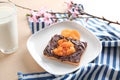 Plate with creative sweet toast and glass of milk on table