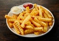 Plate of crinkle cut French fries with dips