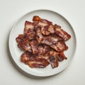 A plate of crispy bacon, isolated on a white background, emphasizing a Royalty Free Stock Photo