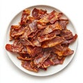 A plate of crispy bacon, isolated on a white background, emphasizing a Royalty Free Stock Photo