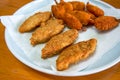 A plate of crispy and delicious fried butterfly prawns and fried cod sticks Royalty Free Stock Photo